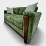 deep green sofa showing the arm trim in real wood custom made